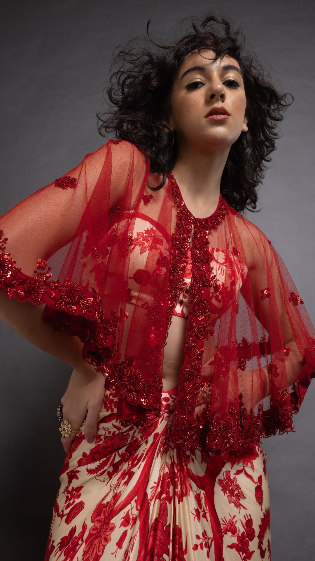 Solid Red Embroidered Single Button Short Cape with Abstract Printed Bustier and Floral Jaal Printed Drape Skirt