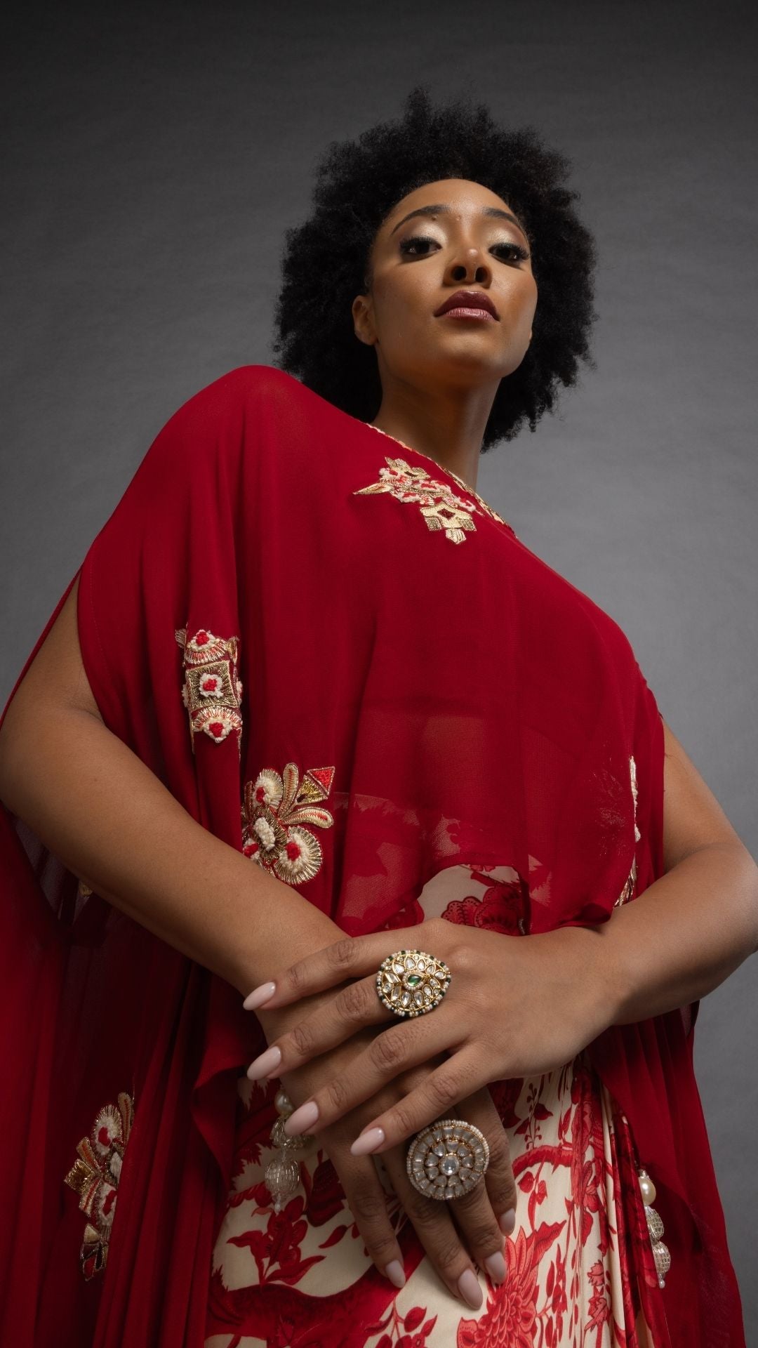 Red Embroidered Short Closed Neck Poncho with A Bustier and Floral Jaal Printed Drape Skirt